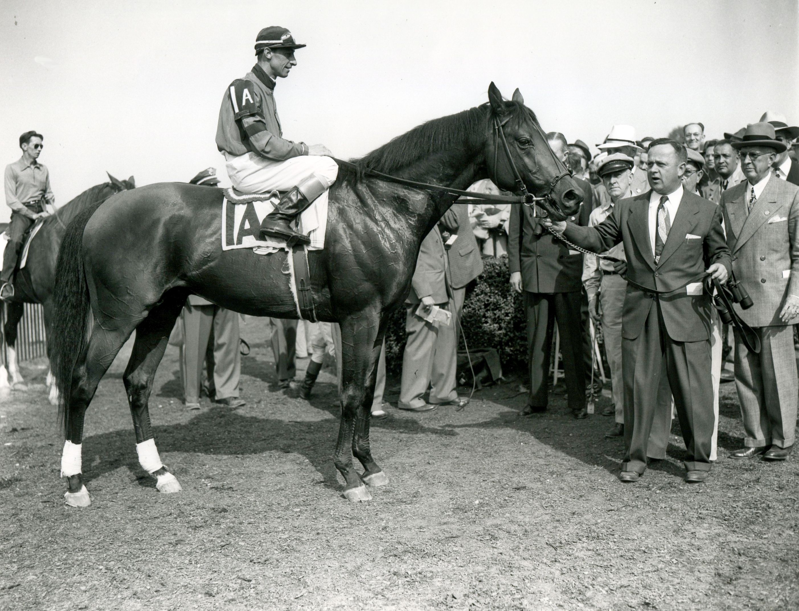 Citation (Eddie Arcaro up) being held by trainer Horace A. "Jimmy" Jones after winning the 1948 Belmont Stakes (Keeneland Library Morgan Collection/Museum Collection)