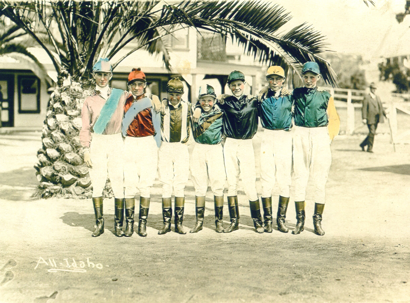 Colorized photograph of a jockey colony featuring Laverne Fator, Mark Fator, Art Mortensen, G. Dick Johnson, Ivan Parke, and two unidentified riders (from left to right) (Museum Collection)