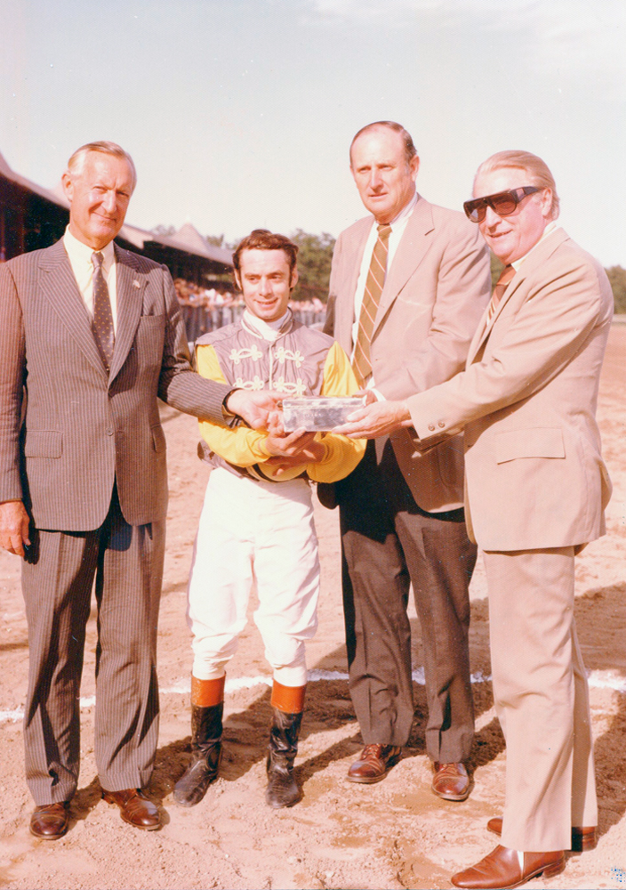 Paul Mellon, jockey Michael Venezia, and trainer MacKenzie Miller receive the trophy for the 1977 Jim Dandy (won by Music of Time) at Saratoga Race Course (Bert and Richard Morgan/Museum Collection)
