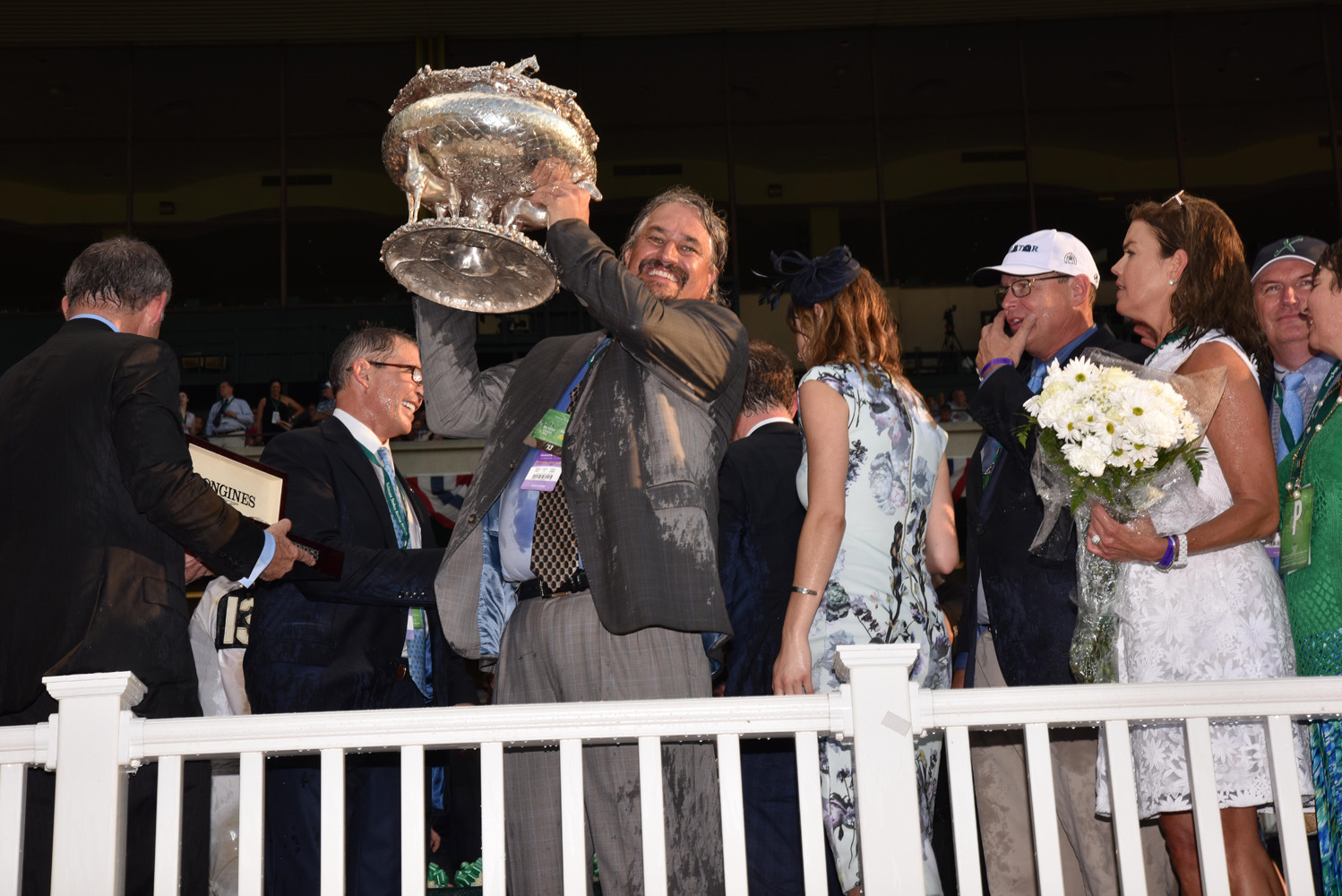 Steve Asmussen holds up the August Belmont Memorial Trophy after winning his first Belmont Stakes with Creator in 2016 (NYRA)