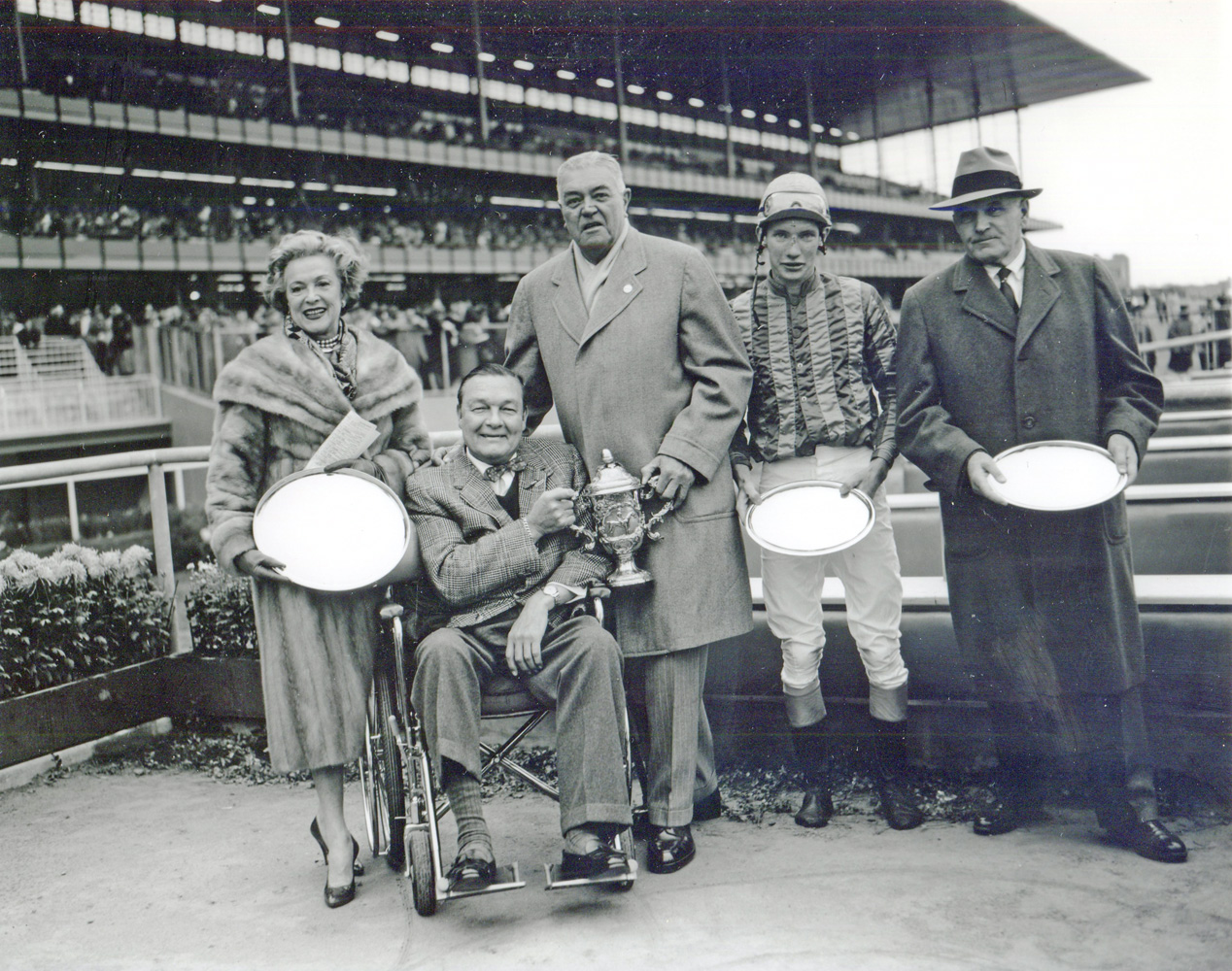 Mr. and Mrs. Stephen "Laddie" Sanford, S. Bryce Wing, jockey Thomas Walsh, and trainer Hollie Hughes at the 1959 Grand National Steeplechase trophy presentation (won by Sun Dog) (Keeneland Library Morgan Collection/Museum Collection)